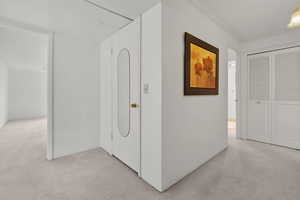 Hallway featuring ornamental molding