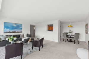 Carpeted living room with ornamental molding