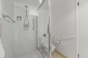 Full bathroom with a shower stall and tile patterned flooring