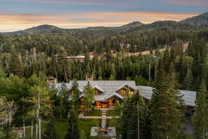 View of mountain backdrop featuring a heavily wooded area
