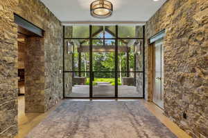 Entryway featuring a wall of windows and wood finished floors