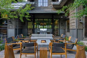 View of patio / terrace with an outdoor living space with a fire pit and a grill
