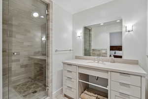Ensuite bathroom featuring vanity and a shower stall