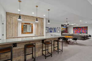 Bar area with recessed lighting, carpet, and pendant lighting