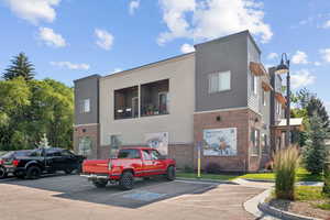 View of property with uncovered parking