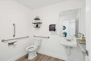 Bathroom featuring toilet and wood finished floors