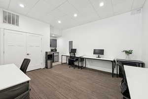 Office space with recessed lighting, a drop ceiling, and electric panel