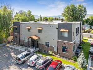 View of building exterior with a mountain view and uncovered parking