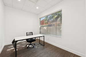Office with a drop ceiling and recessed lighting