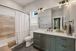 Bathroom featuring vanity and shower / bath combination with curtain