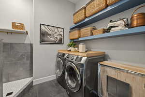 Laundry area with washing machine and clothes dryer and baseboards
