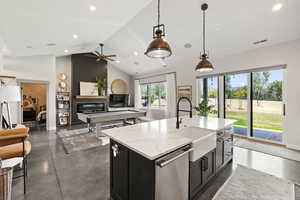 Kitchen featuring stainless steel dishwasher, dark cabinetry, hanging light fixtures, recessed lighting, and a ceiling fan