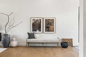 Sitting room featuring baseboards and wood finished floors