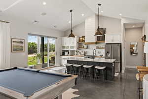 Rec room with high vaulted ceiling, concrete flooring, recessed lighting, and pool table