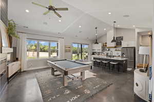 Playroom featuring billiards table, concrete flooring, ceiling fan, high vaulted ceiling, and recessed lighting