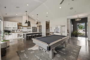 Game room featuring concrete flooring, billiards table, high vaulted ceiling, ceiling fan, and recessed lighting