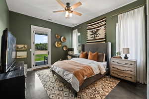 Bedroom featuring access to outside, concrete flooring, and ceiling fan