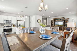 Dining room featuring recessed lighting, wood finished floors, and a chandelier