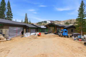 View of front of house with stone siding and a mountain view
