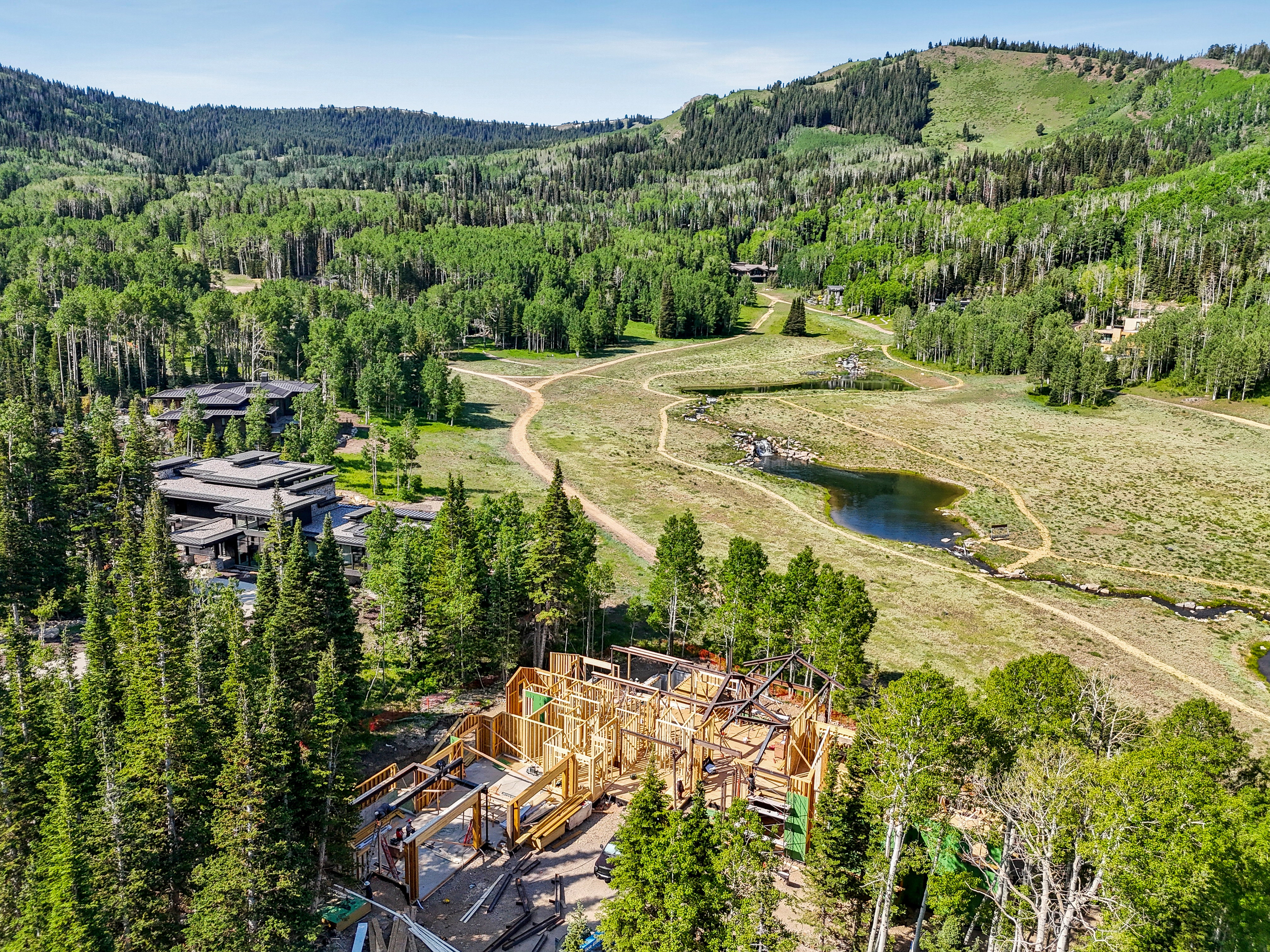 Bird's eye view of a heavily wooded area and a large body of water