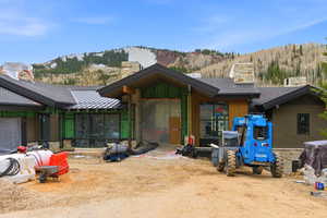 View of front facade with a standing seam roof, a chimney, and a mountain view