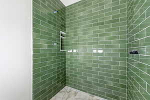 Full bath featuring a tile shower
