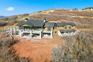 Back of property with a chimney and a patio