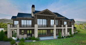 Back of property featuring a standing seam roof, a balcony, a metal roof, and a chimney