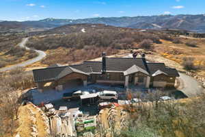 Aerial view of property and surrounding area with mountains