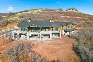 Rear view of house featuring a chimney and a patio area
