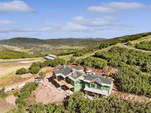 View from above of property with a mountain backdrop