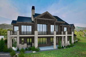 Rear view of house featuring a metal roof, a standing seam roof, a chimney, a mountain view, and a lawn