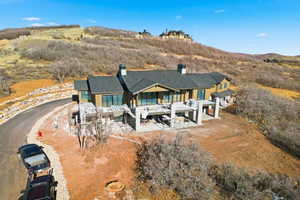 Back of house with a patio and a chimney