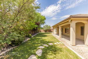Fenced backyard with a patio