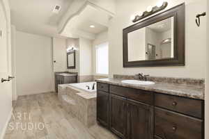 Full bath with a bath and two vanities