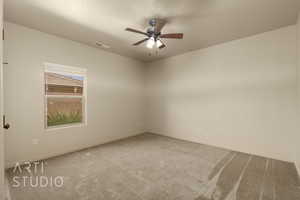 Unfurnished room featuring carpet floors and a ceiling fan