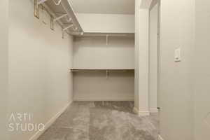 Walk in closet with carpet flooring
