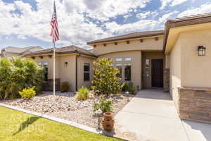 View of exterior entry featuring stucco siding and a tile roof