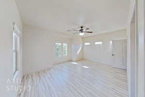 Spare room featuring a ceiling fan and light wood-style floors