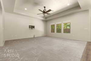 Carpeted empty room featuring a tray ceiling, ceiling fan, a textured ceiling, and recessed lighting