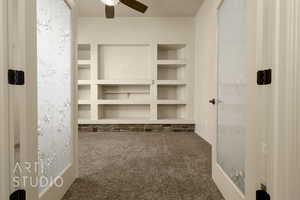 Spacious closet featuring carpet and a ceiling fan