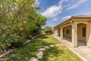 Fenced backyard with a patio area
