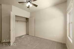 Unfurnished bedroom with carpet flooring, a closet, and a ceiling fan