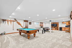 Game room with light colored carpet, recessed lighting, billiards, bar with sink, and a fireplace