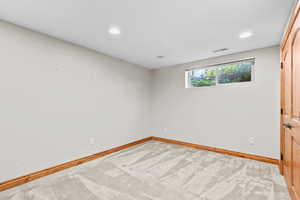 Spare room featuring carpet flooring and recessed lighting