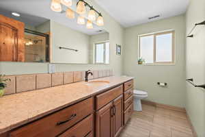 Bathroom featuring vanity and an enclosed shower