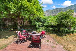 View of patio / terrace with a fire pit and a mountain view
