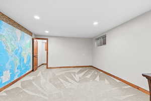 Finished basement featuring recessed lighting and light colored carpet