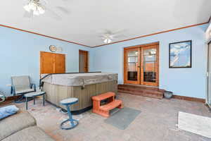 View of patio / terrace with french doors, ceiling fan, and an indoor hot tub