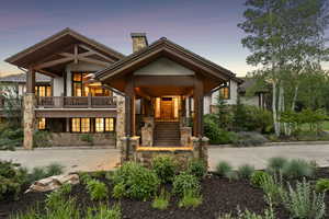 View of front facade with a chimney and stone siding